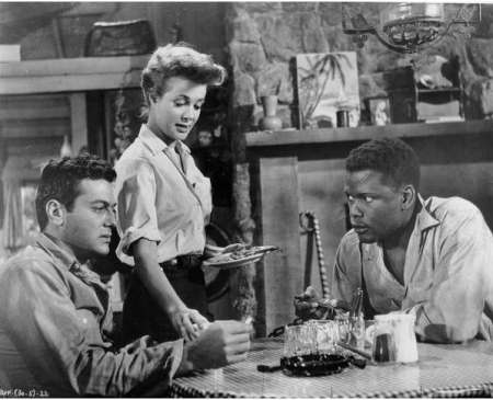 Actors Tony Curtis, Cara Williams and Sidney Poitier are shown in a scene from the 1958 film "The Defiant Ones"