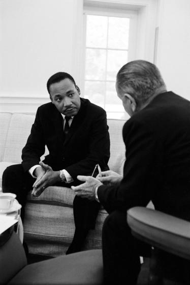 (L-R) Civil rights leader Dr. Martin Luther King speaking with President Lyndon Johnson during a visit to the White House.