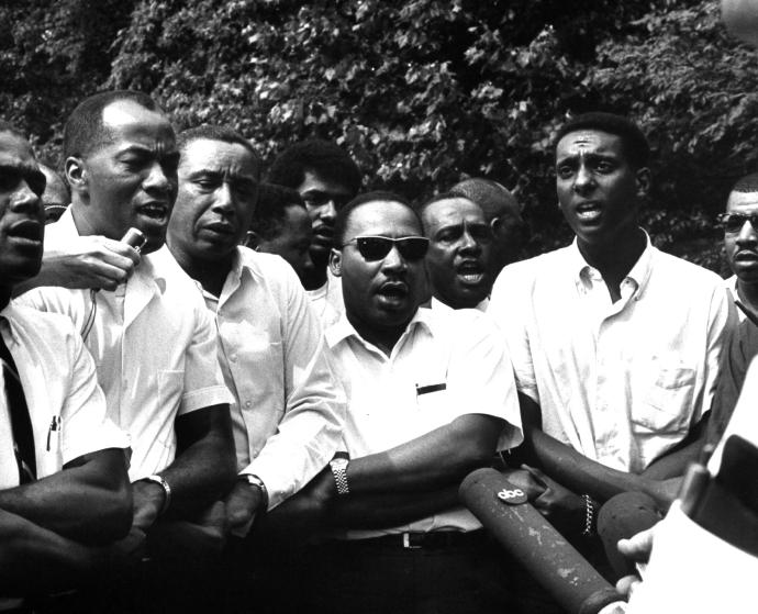 Civil rights leaders Floyd B. McKissick (fore, 3L), Dr. Martin Luther King Jr. (4R) and Stokely Carmichael (2R) participating in voter registration march after originator James H. Meredith was shot.