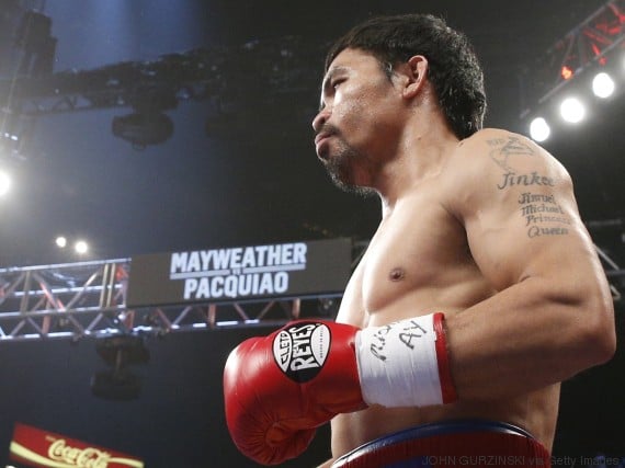 Manny Pacquiao arrives in the ring for his welterweight unification championship bout with Floyd Mayweather Jr., May 2, 2015 at MGM Grand Garden Arena in Las Vegas, Nevada. Mayweather defeated Pacquiao by unanimous decision. AFP PHOTO / JOHN GURZINKSI (Photo credit should read JOHN GURZINSKI/AFP/Getty Images)