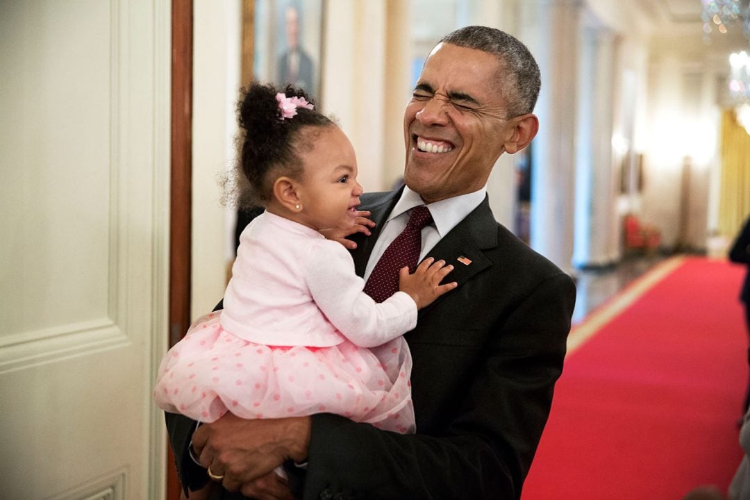 President Barack Obama holds the daughter of former staff member Darienne Page Rakestraw in the Cross Hall of the White House, April 3, 2015. (Official White House Photo by Pete Souza) This official White House photograph is being made available only for publication by news organizations and/or for personal use printing by the subject(s) of the photograph. The photograph may not be manipulated in any way and may not be used in commercial or political materials, advertisements, emails, products, promotions that in any way suggests approval or endorsement of the President, the First Family, or the White House.