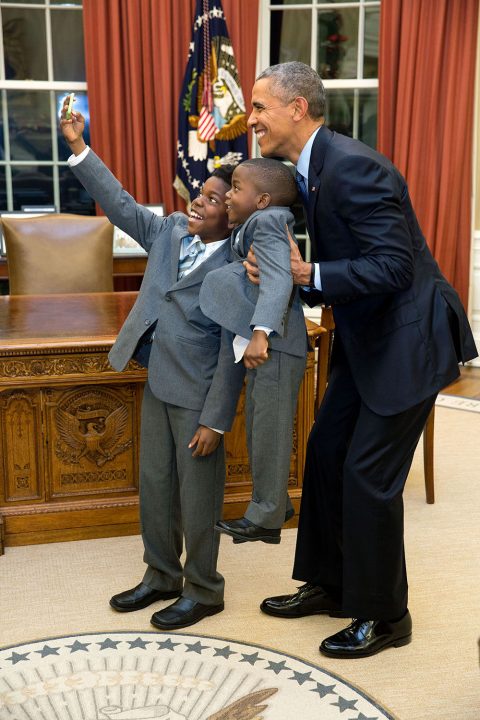 Dec. 4, 2015 "The President acquiesced to a selfie with 11-year-old Jacob Haynes and four-year-old James Haynes after taking a family photograph with departing White House staffer Heather Foster." (Official White House Photo by Pete Souza) This official White House photograph is being made available only for publication by news organizations and/or for personal use printing by the subject(s) of the photograph. The photograph may not be manipulated in any way and may not be used in commercial or political materials, advertisements, emails, products, promotions that in any way suggests approval or endorsement of the President, the First Family, or the White House.