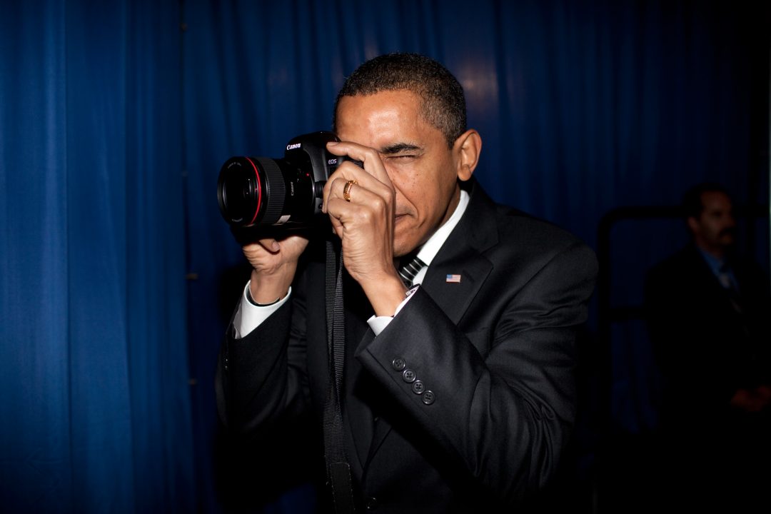 President Barack Obama takes aim with a photographer's camera backstage prior to remarks about providing mortgage payment relief for responsible homeowners. Dobson High School. Mesa, Arizona 2/18/09. Official White House Photo by Pete Souza