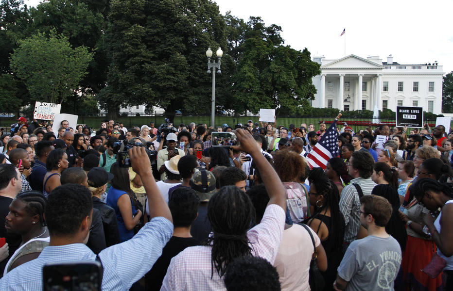 People rally near the White House during over protest about police brutality, Thursday, July 7, 2016, in Washington. (AP Photo/Paul Holston)