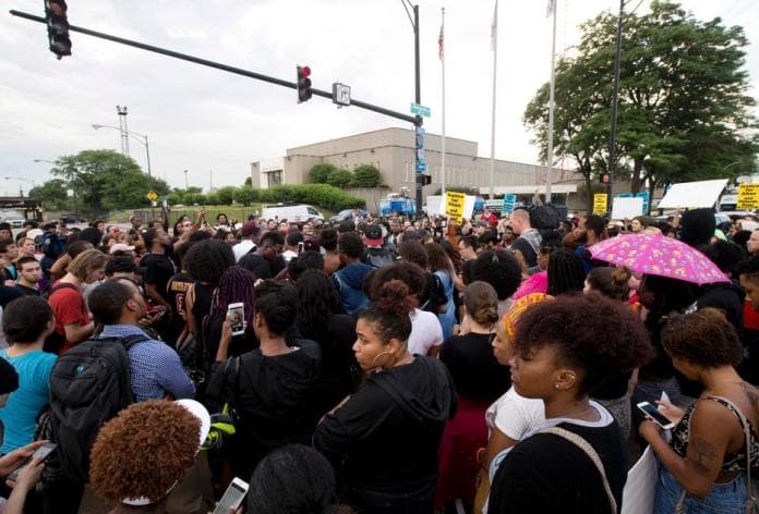 Protestors march in front of Police District 2 Station in Chicago on July 2016 after the video Alton Sterling being killed by Baton Rouge Police Department was released last night. Black motorist Philando Castile, 32, a school cafeteria worker, was shot at close range by a Minnesota cop and seen bleeding to death in a graphic video shot by his girlfriend that went viral Thursday, the second fatal police shooting to rock America in as many days. / AFP PHOTO / Tasos Katopodis
