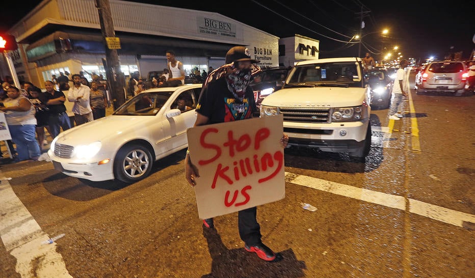 Protestors congregate at N. Foster Dr. and Fairfields Ave., the location of the Triple S convenience store in Baton Rouge, La., Wednesday, July 6, 2016. Alton Sterling, 37, was shot and killed outside the store by Baton Rouge police, where he was selling CDs. (AP Photo/Gerald Herbert)